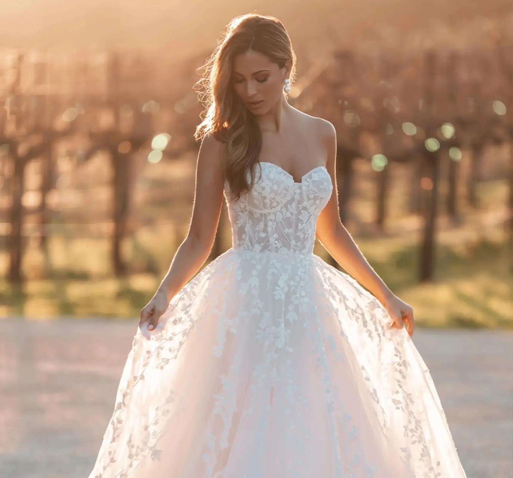 Model wearing a white gown by Allure Bridals