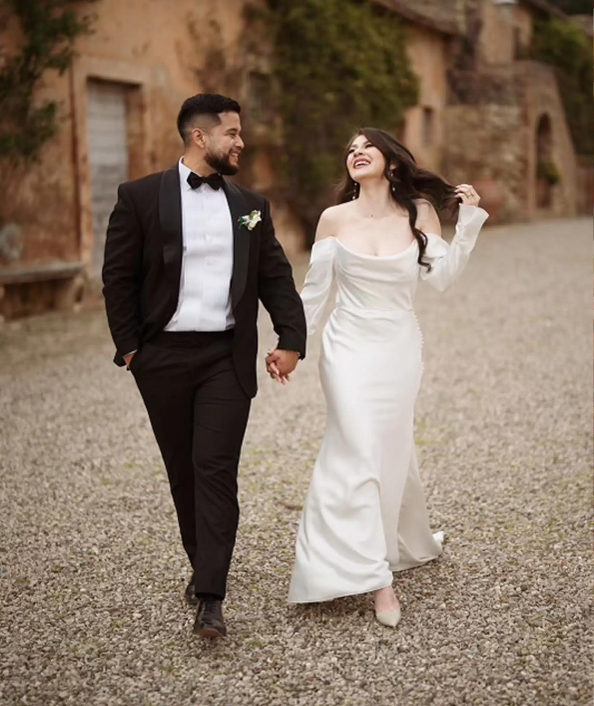 Сouple wearing a white gown and a brown suit