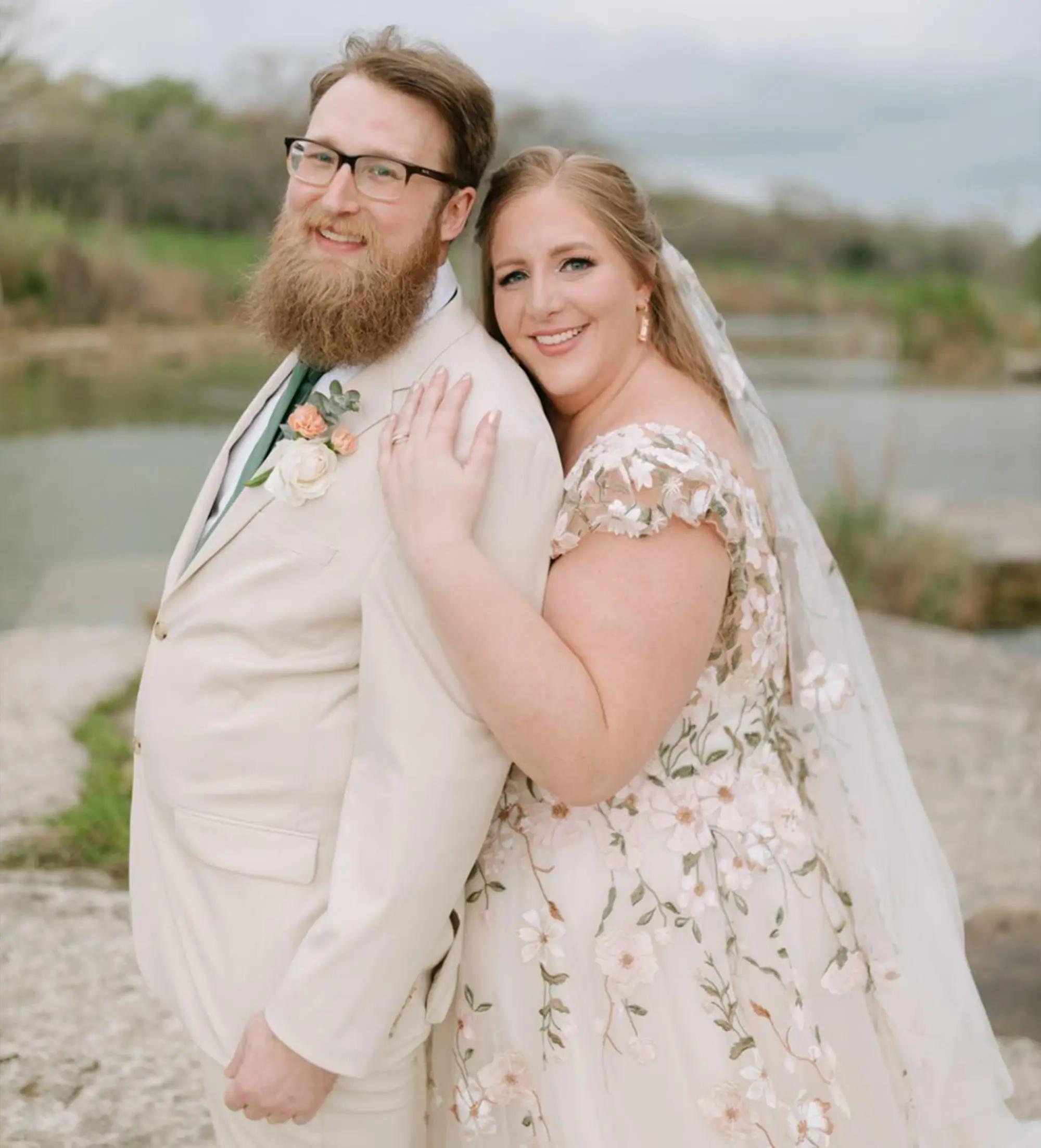 Сouple wearing a white gown and a black suit